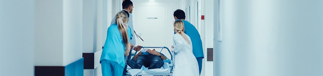 Medics with trolley in corridor